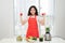 Happy fitness. Asian woman with dumbbells and fresh drink