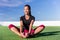 Happy fitness Asian woman stretching legs in park