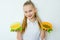 Happy fitness girl holding canned peas and corn