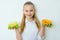 Happy fitness girl holding canned peas and corn