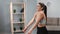 Happy fitness woman warming up shoulders rotating doing workout body care and healthy lifestyle