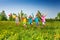 Happy five children with balloons run in field