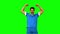 Happy football player raising arms on green screen