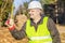 Happy forest engineer with a tape measure in forest