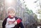 Happy four yearold boy sitting in forest outside