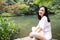 A happy free smile peace balance meditation beauty girl Asian Chinese travel hiking smell maple do yoga by lake bag hangzhou xihu