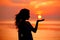 Happy free Woman enjoying in Sea Sunset. Silhouetted against the