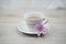 Happy Friday. Friday concept with cup of morning coffee and a purple flower on soft white table backgrounds. Relax weekend.