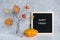 Happy Friday text on black letter board and bouquet of branches with yellow leaves on clothespins in vase on table Template for