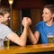 Happy friend arm wrestling each other