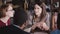 Happy friendly businesswoman listening to her colleague at multiethnic office board meeting by the table close-up.