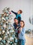 Happy friendly family decorating Christmas tree have fun