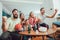 Happy friends or basketball fans watching basketball game on tv