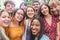 Happy friends from diverse cultures and races taking photo making funny faces - Millennial generation and friendship concept with