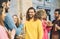 Happy friends eating street food and drinking beers outdoor - Group trendy people having fast meal together