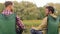 Happy friends fishing and talking on lake