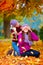 Happy friends, girls playing in vibrant autumn park