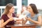 Happy friends having a conversation in a bar