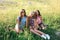 Happy friends in the park on a sunny day . Summer lifestyle portrait of three hipster women enjoy nice day, wearing bright sunglas