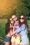 Happy friends in the park on a sunny day . Summer lifestyle portrait of three hipster women enjoy nice day, wearing bright sunglas