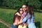 Happy friends in the park on a sunny day . Summer lifestyle portrait of three hipster women enjoy nice day, wearing bright sunglas