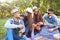 Happy friends on a picnic in the park.