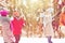 Happy friends playing snowball in winter forest