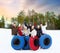 Happy friends with snow tubes outdoors in winter