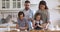 Happy full family kneading dough, having fun together at home.