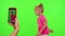 Happy funky blogger child kid girl, recording funny dancing video on smartphone for social network