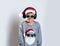 Happy funny child boy face portrait. Cool and confidant kid in sun glasses and Santa Claus shirt holding gift box