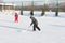 Happy funny kids playing hockey at the rink