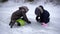 The happy and funny kids sitting on the frozen lake and wipe the ice. Two guys smiling and genuinely happy. The gloomy