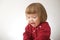 Happy funny little girl emotional playing. cute caucasian blond baby girl with bear and doll