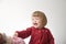 Happy funny little girl emotional playing. cute caucasian blond baby girl with bear and doll
