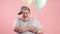 Happy funny man much similar to Winnie the Pooh with air baloons isolated over pink background