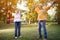 Happy funny senior couple playing hulahop in park