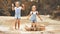 Happy funny sisters twins child girl jumping on puddles in rub