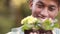 Happy gardener holding a plant