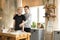 Happy gay couple, one asian with blonde hair in glasses second european in casual wear having breakfast in the kitchen