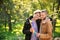 Happy gay couple with rainbow flags in park