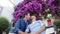 Happy gay couple sitting on bench in park and doing selfie