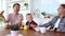 Happy gay family two fathers and son are having breakfast in the kitchen.