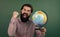 happy geographer man with beard look at globe. ready for studying. nonformal education. student in school classroom