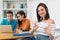 Happy german female student with group of computer science students