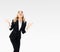 Happy gesturing young businesswoman, grey background, with copy space