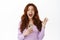 Happy ginger girl screams, holds smartphone and smiling, celebrating big news, online promotion, standing in blouse