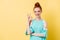 Happy ginger woman in dress showing ok sign