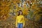 Happy girl in autumn forest with yellowing leaves