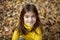 Happy girl in autumn forest with yellowing leaves